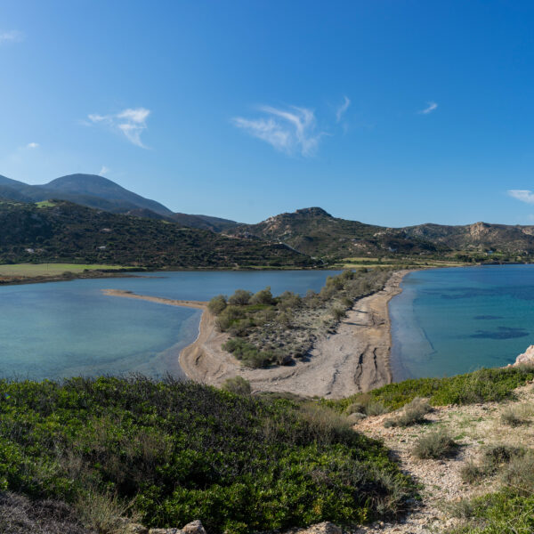 A collection of high-resolution Cycladic landscape backgrounds featuring clear blue skies and occasional cloud formations.